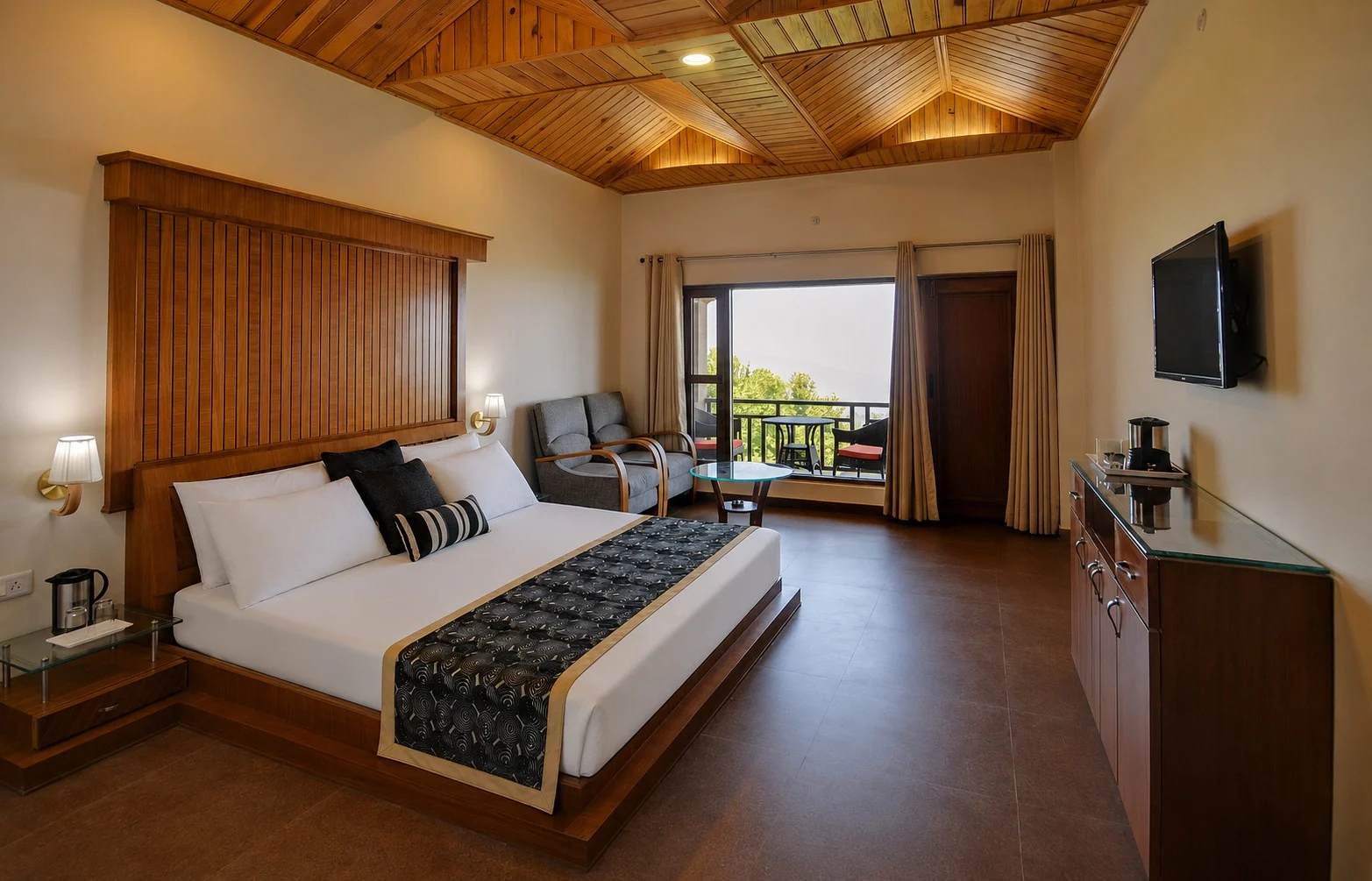 Bright hotel room with a wooden ceiling, king bed, sitting area, and balcony view.