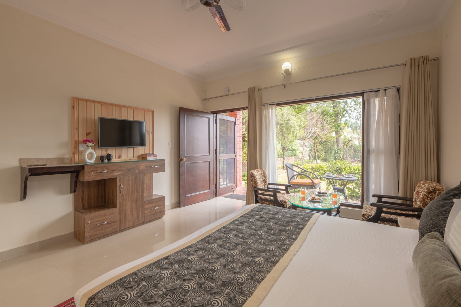 Deluxe Room at Ojaswi Resort Mukteshwar featuring warm wooden interiors and peaceful garden-facing views.