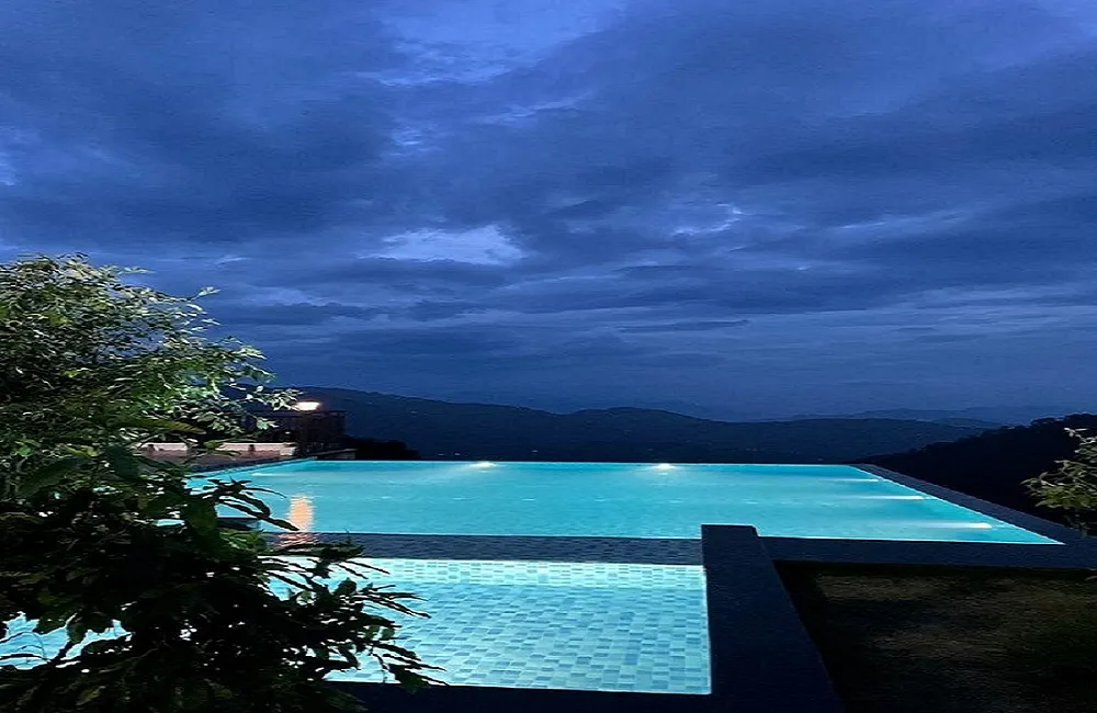 Cloud-covered sky above the pool at Ojaswi Resort