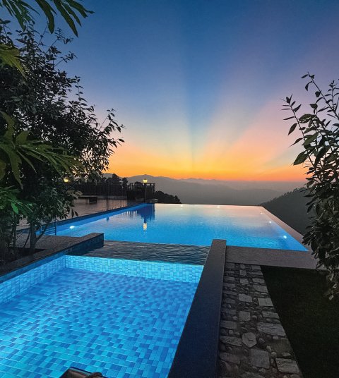 Infinity pool at Ojaswi Resort in Mukteshwar overlooking Himalayan ridges during a serene sunset tea experience