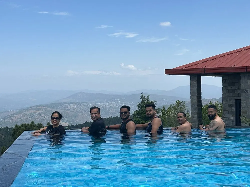 Family enjoying quality time together in the swimming pool at Ojaswi Himalayan Resort