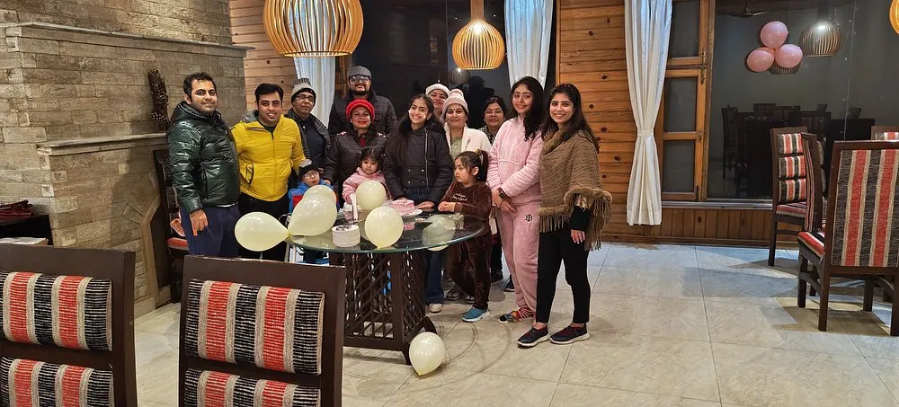 Family celebrating a birthday together at Ojaswi Resort