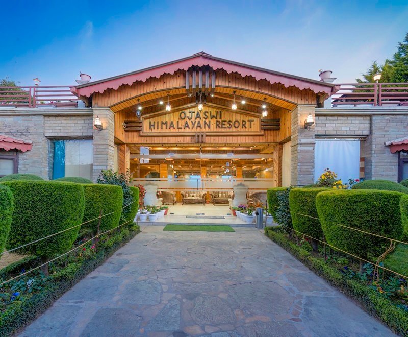 Families enjoying a delicious meal together at Ojaswi’s restaurant, highlighting the resort's welcoming environment.