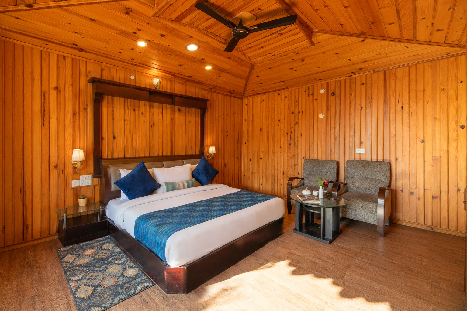 Deluxe Room at Ojaswi Resort Mukteshwar featuring warm wooden interiors and peaceful garden-facing views.