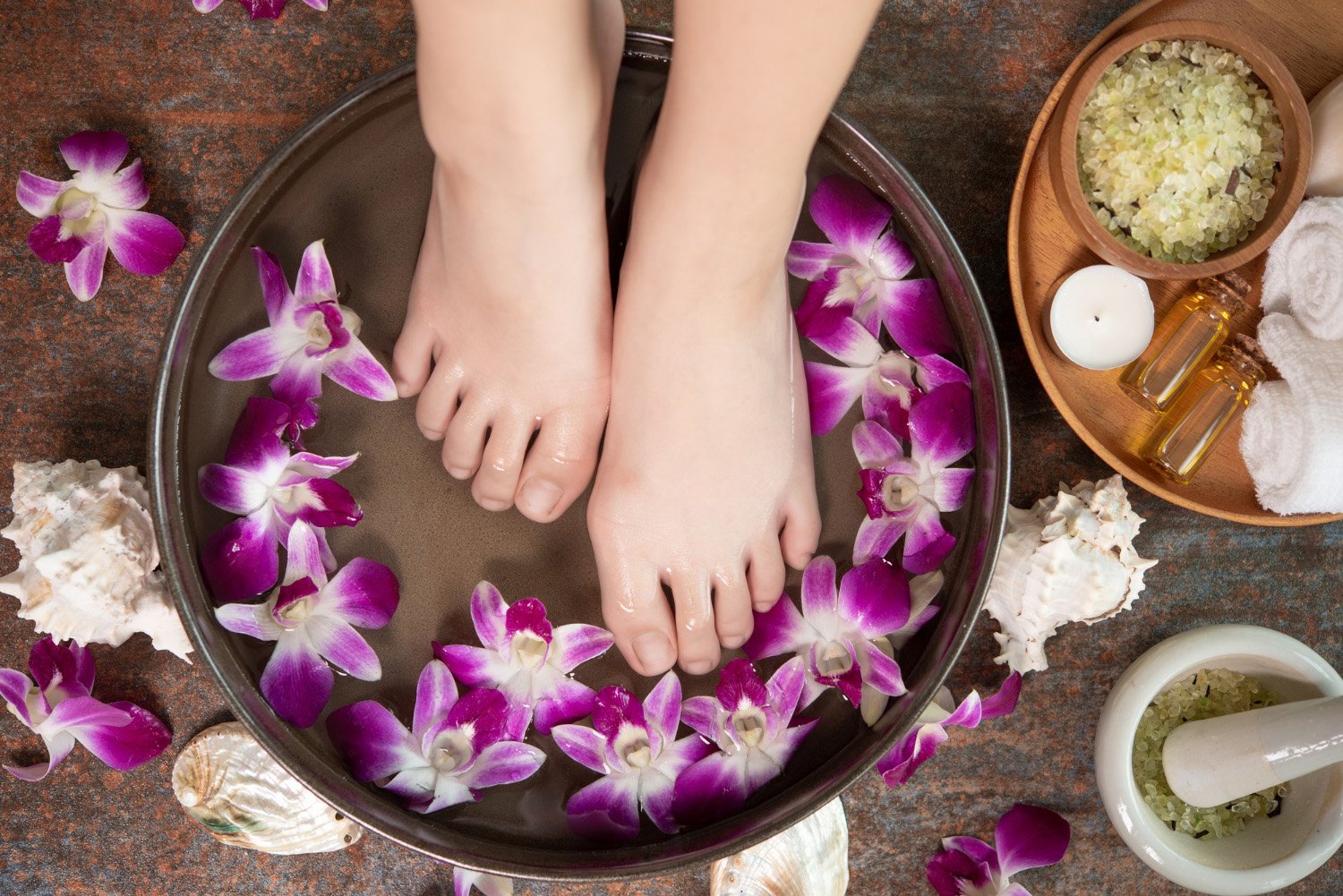 A relaxing spa experience at Ojaswi Resort, showing a woman receiving a hot stone massage against a scenic mountain backdrop.